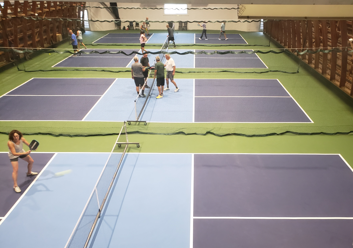 Athletes playing pickleball on pickleball courts