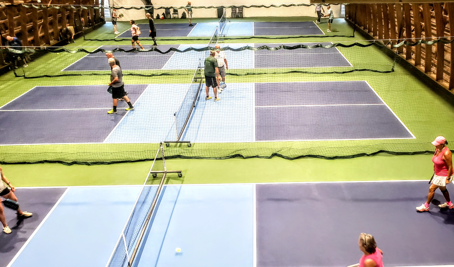 People playing on a pickleball court